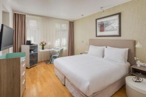 A bed or beds in a room at Casati Hotel - Adults Only