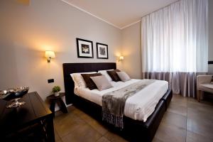 Postel nebo postele na pokoji v ubytování Delle Vittorie Luxury Rooms&Suites