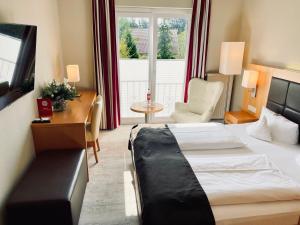 Postel nebo postele na pokoji v ubytování Moin Hotel Cuxhaven