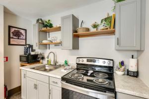 a kitchen with a stove and a sink at Historic Vacation Rental in Downtown Rapid City! in Rapid City +16 photos