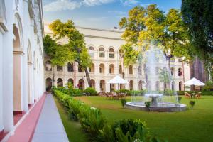 a courtyard with a fountain in front of a building at The Grand Imperial - Heritage Hotel in Agra