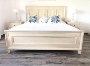 a large white bed with pillows on it in a bedroom at Dickenson Bay Oasis at Antigua Village in Saint Johnʼs