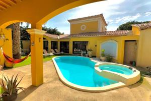 a pool in the backyard of a house at La villa Soleil in Fourques