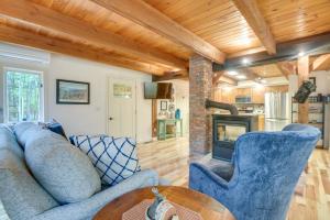 a living room with blue chairs and a fireplace at North Conway Vacation Rental Near Saco River! in North Conway