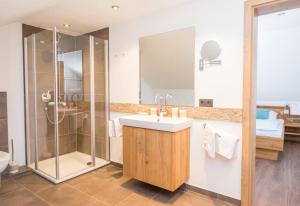 a bathroom with a sink and a shower at Der Kolmenhof - Dein Ort an der Quelle in Furtwangen +56 photos