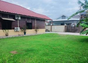 a house with a lawn in front of it at Ipoh Buntong Corner homestay in Ipoh