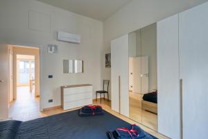 a bedroom with a bed and a large mirror at Appartamento Centro Torino con Terrazzo in Turin