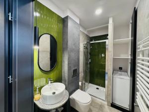 a bathroom with a sink and a toilet and a mirror at Tkalnia Snu in Łódź