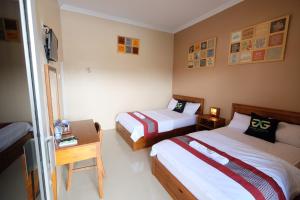 Ένα ή περισσότερα κρεβάτια σε δωμάτιο στο Griya Gayatri Monjali Syariah