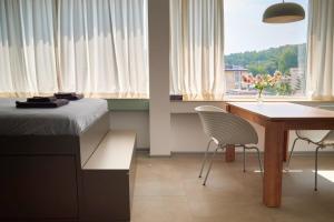 a bedroom with a bed and a desk and a table at Studio Rosa in Gabrovo