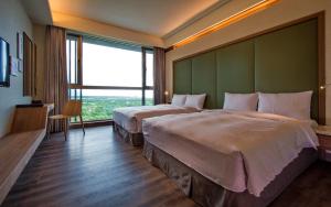 Postel nebo postele na pokoji v ubytování Taroko Liiko Hotels