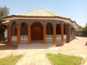 a small building with a porch with a roof at Cosy Hideout Coastal Road Green House in Ghana Town