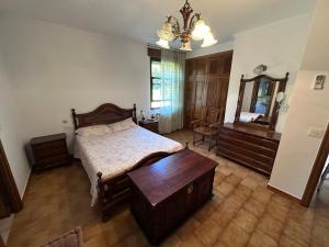 a bedroom with a bed and a dresser and a mirror at Casa Lugar de Fidalgo in Vilamor
