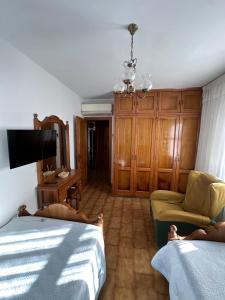 a bedroom with a bed and a chair and a tv at Casa Lugar de Fidalgo in Vilamor