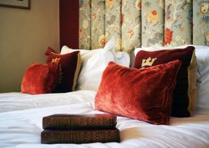 a hotel room with two beds with red pillows at The Windsor Townhouse Air conditioned rooms in Bath