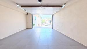 an empty room with white walls and an open door at Cantinho da Feira in Parada de Ester