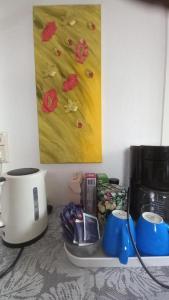 a kitchen counter with a coffee maker and a painting at City Apartment Cologne in Cologne