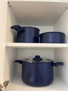 three blue pots on a shelf in a kitchen at City Apartment Cologne in Cologne