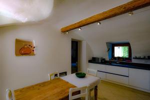 a room with a table and a kitchen with a table and chairs at Corvina By Zeni in Costermano sul Garda +11 photos