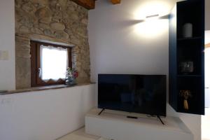 a living room with a flat screen tv on a white wall at Corvina By Zeni in Costermano sul Garda