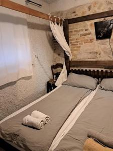 a bedroom with a bed with two towels on it at Comfortable Apartment in Betina, terrace, 55 m², air-conditioned in Betina