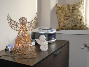 une table avec une statue d'ange et une horloge. dans l'établissement Apartments Sobieski&Soplica, à Cracovie