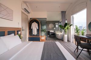 En eller flere senge i et værelse på Keypad Hotel - Linh Lang