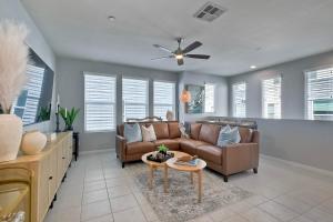 a living room with a couch and a table at Blocks To Beach - Coastal Beach Decor - Garage Parking - Gated Community - 30 Day Fully Furnished in Oceanside
