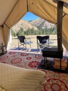a room with two chairs and a table in a tent at Tent 2 Oxen-Le-Fields Montana in Conner +4 photos