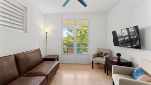 a living room with a couch and a chair at Casita 3 at Ceiba Tree Inn. Tranquility with Garden Views and Pergola with Ocean Overlook in Rincon