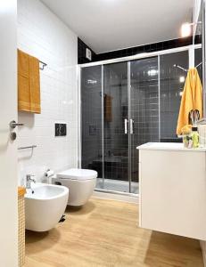 a bathroom with a shower and a toilet and a sink at Domus da Ria - Alboi III in Aveiro