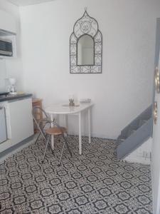 a table and chairs in a room with a bed at Petit studio sud gare in Rennes