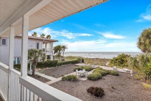 a view of the ocean from the porch of a house at Beach Trail Bungalow Triplex in Clearwater Beach