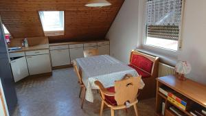 a kitchen with a table and a table and chairs at Ferienwohnung in Ländliche Gegend die zum Verweilen einlädt in Wachenroth +4 photos