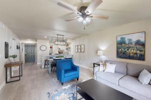 a living room with a couch and a dining room at Wholesome Hideout in Branson