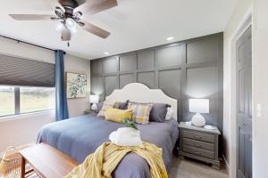 a bedroom with a bed and a ceiling fan at Wholesome Hideout in Branson +23 photos