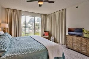 a bedroom with a large bed and a large window at Seacrest - Beach Blessing in Panama City Beach +17 photos