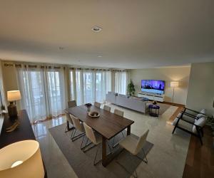a living room with a dining table and a couch at Madeira Luxury Villas Living Funchal in Funchal