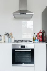 a kitchen with a black stove top oven at Charlotte Street Apartment in Bath +14 photos