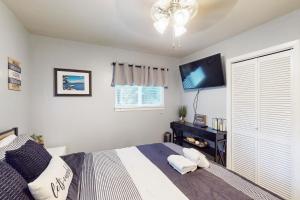 a bedroom with a bed and a flat screen tv at Peaceful Pines Retreat in Mevers