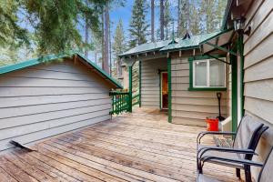 a house with a wooden deck with a building at Peaceful Pines Retreat in Mevers