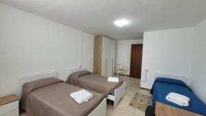 Postel nebo postele na pokoji v ubytování Corte Azzurra Iris