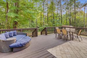a deck with a couch and a table and chairs at Grand Retreat Sleeps 12 Spacious Deck and WiFi in Fairington