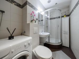 a bathroom with a washing machine and a sink at Luxury apartment Piękna in Warsaw +45 photos