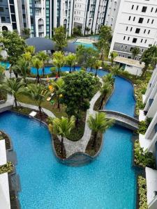 an overhead view of a pool with palm trees and buildings at Super Naiyang Title 1Bdr 600m to beach in Nai Yang Beach