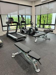 a gym with three treadmills and cardio machines at Super Naiyang Title 1Bdr 600m to beach in Nai Yang Beach