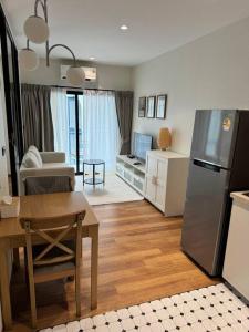 a kitchen and living room with a table and a refrigerator at Super Naiyang Title 1Bdr 600m to beach in Nai Yang Beach +13 photos