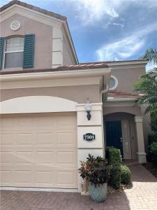 a house with a garage with a sign on it at Botanica Condo in Sarasota