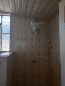 a bathroom with a shower in a wall at Simples e confortável in Londrina +21 photos