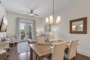 a dining room and living room with a table and chairs at Blue Mtn Beach - Red Vill 219 in Santa Rosa Beach